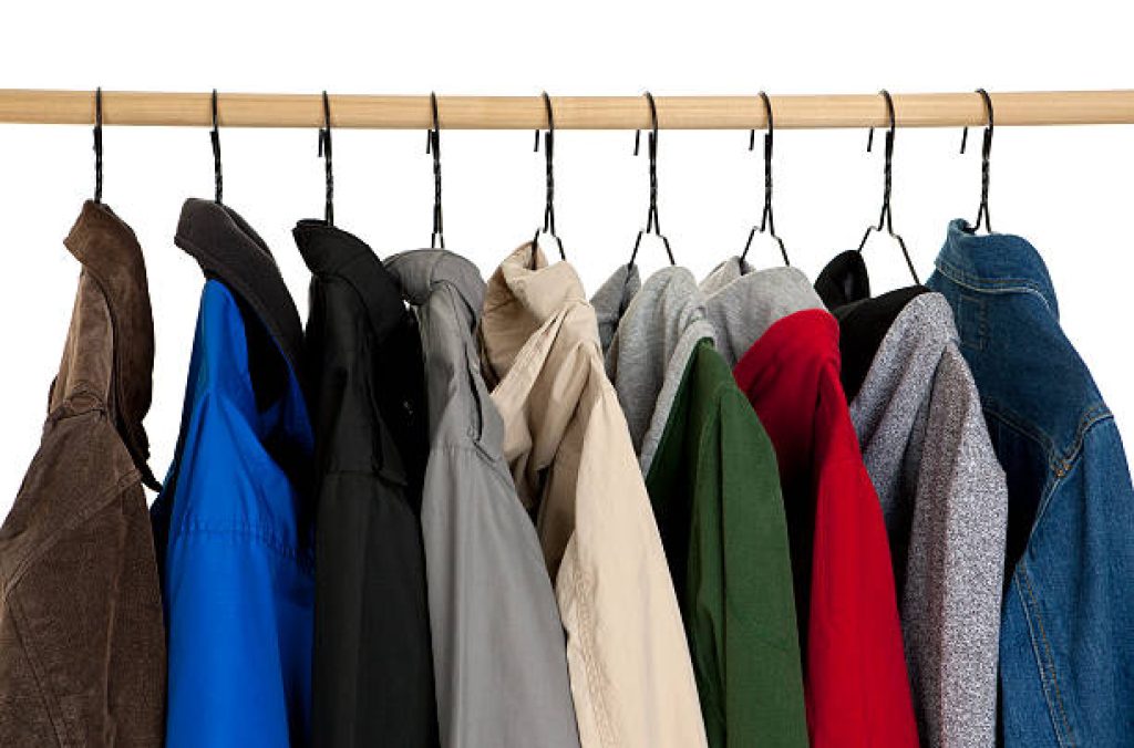 Several coats hanging on a rack.Please also see: